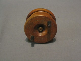 A wooden and brass fishing reel by Millard 3"