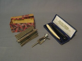 A metal framed wool winder and 2 cut throat razors