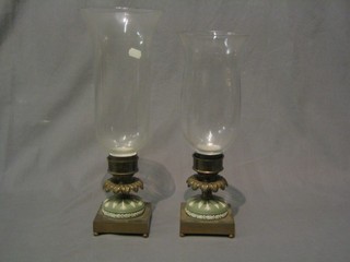 A pair of 19th Century green Jasperware and gilt metal mounted candlesticks complete with storm glasses