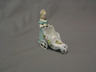 A 19th Century Continental porcelain figure of a walking girl with pram with moving legs