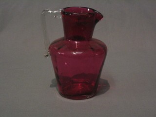 A Victorian cranberry glass ewer with clear glass handle 7"