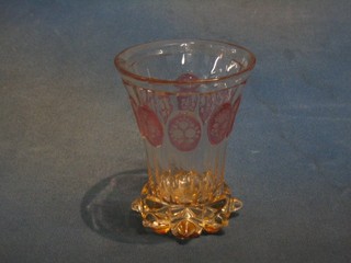 A Bohemian pink overlay waisted glass beaker with studded decoration to the base 5"