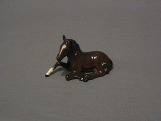 A Royal Doulton figure of a seated foal 4"