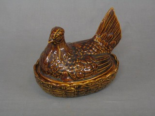 A Port Meirion brown glazed egg store in the form of a seated hen 