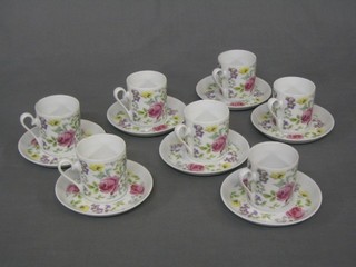 A set of 7 Continental porcelain coffee cans and saucers with floral decoration