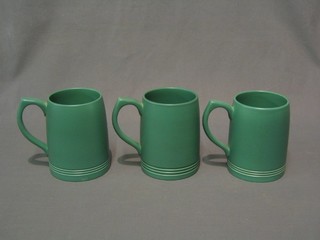 3 Wedgwood Keith Murray green glazed tankards the bases impressed with an E and with Keith Murray signature
