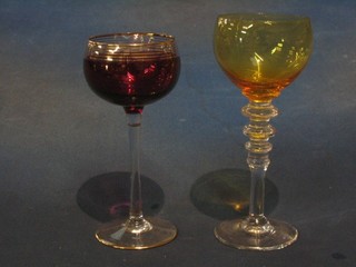 A set of 6 long stemmed hock glasses with amber bowls and a set of 5 hock glasses with red bowls