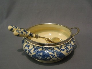 A circular Victorian blue and white pottery twin handled salad bowl with silver plated mounts and a matching pair of servers