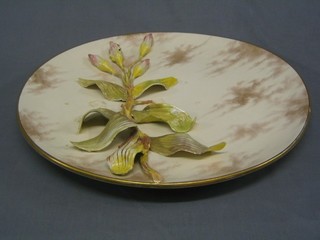 A Circular Doulton charger with applied decoration, the base impressed Doulton Lambeth 3=84 (some damage to front) 19"