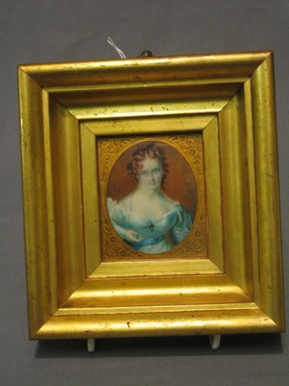 An enhanced miniature print of a lady in blue dress 3" oval contained in a decorative gilt  frame