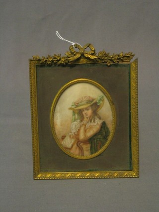 An oval portrait miniature on ivory of a seated and bonnetted lady 4", contained in a decorative gilt frame