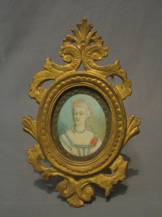 A 19th Century portrait miniature on ivory of a lady contained in a carved wooden frame 4" oval