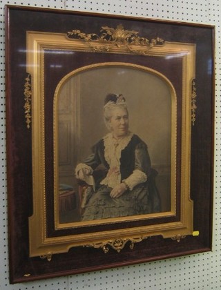A Victorian enhanced black and white photograph of a seated lady contained in a decorative gilt frame 29" x 25"