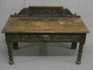 A Victorian carved oak side table/hall bench with raised back fitted a drawer and raised on bobbin turned supports 41"