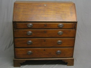 A Georgian mahogany bureau, the fall front revealing a well fitted interior, the base fitted 4 long drawers 40"