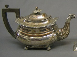 A Georgian Sheffield plate teapot with griffin spout, raised on 4 bun feet