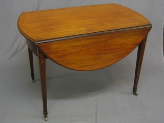 A Georgian mahogany oval Pembroke table fitted a bow front drawer, raised on square tapering supports with inlaid stringing ending in brass caps and castors 41"
