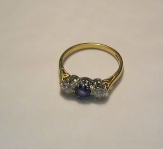 A lady's 18ct gold dress ring set a sapphire and 2 diamonds