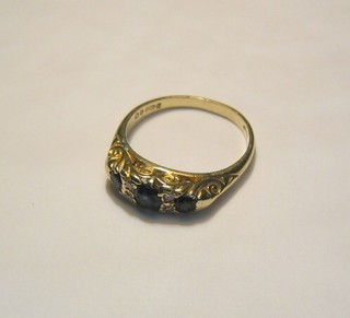 A lady's 9ct gold dress ring set 3 sapphires and 4 diamonds