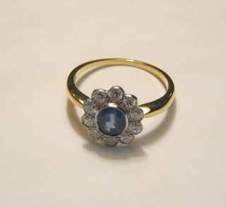 A lady's 18ct yellow gold dress ring set a circular cut sapphire surrounded by 10 diamonds
