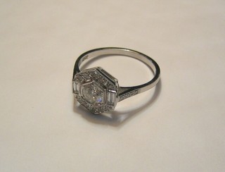 A lady's 18ct white gold dress ring set a large circular cut diamond supported by diamonds (approx 0.70ct)
