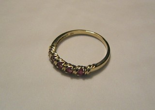 A lady's 9ct gold dress ring set 5 rubies