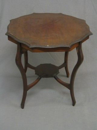 An Edwardian circular walnut 2 tier occasional table raised on cabriole supports 27"