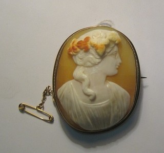 A shell carved cameo portrait brooch of a lady contained in a gilt metal mount