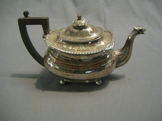 A Georgian Sheffield plate teapot with griffin spout, raised on 4 bun feet