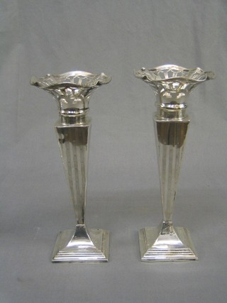 A handsome pair of Victorian square waisted and tapering silver specimen vases with pierced mounts, raised on square bases, Birmingham 1894, 10"