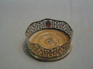 A 19th Century circular pierced silver plated wine bottle coaster