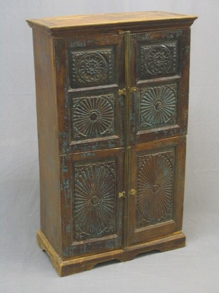 An Eastern carved hardwood cabinet, enclosed by panelled doors 28"