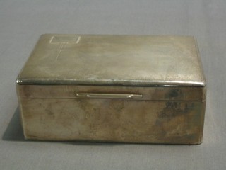 A silver cigarette box with hinged lid and engine turned decoration, Sheffield 1958 6"