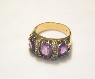 A lady's gold dress ring set an "amethyst" supported by diamonds