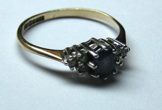 A lady's 9ct gold dress ring set a sapphire, surrounded by 6 white stones