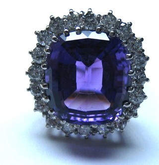 A lady's 18ct gold dress ring set a cushion cut amethyst surrounded by numerous diamonds