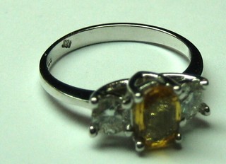 A lady's 18ct white gold dress ring set a yellow sapphire and 2 diamonds