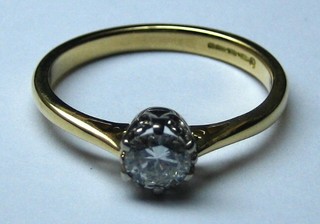 A lady's 18ct gold solitaire engagement/dress ring set a diamond