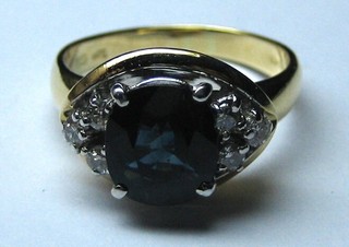 A lady's 18ct gold dress ring set a sapphire to the centre supported by 6 diamonds