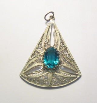 A pierced silver filigree pendant set a blue stone