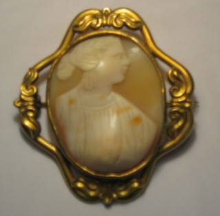 A shell carved cameo portrait of a lady contained in a gilt metal brooch mount
