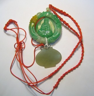 A carved jade coloured pendant and 1 other