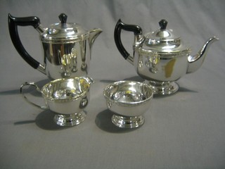 An Art Deco circular 4 piece silver plated tea service comprising teapot, cream jug, sugar bowl and hot water jug 