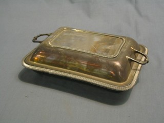 A pair of rectangular silver plated twin handled entree dishes and covers