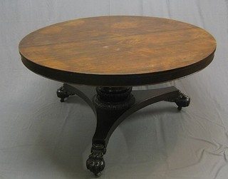A William IV circular snap top rosewood breakfast table, raised on a turned column and triform base with paw feet  55" (crack to top and crack to column)