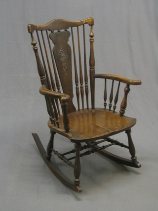 A 19th Century elm bar back rocking chair with carved splat back and solid seat