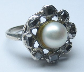 A 19th Century dress ring set a pearl to the centre supported by  rose cut diamonds    
