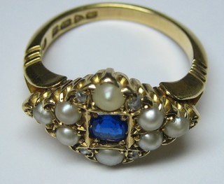 An 18ct gold dress ring set sapphires supported by diamonds and pearls