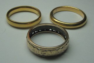 A 22ct gold wedding band and 2 other wedding bands