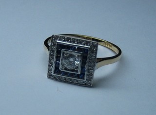A lady's 18ct gold square shaped dress ring set a sapphire surrounded by diamonds  